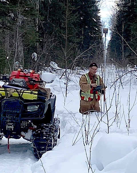 Surveyor working in snow